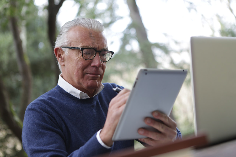older man using tablet 