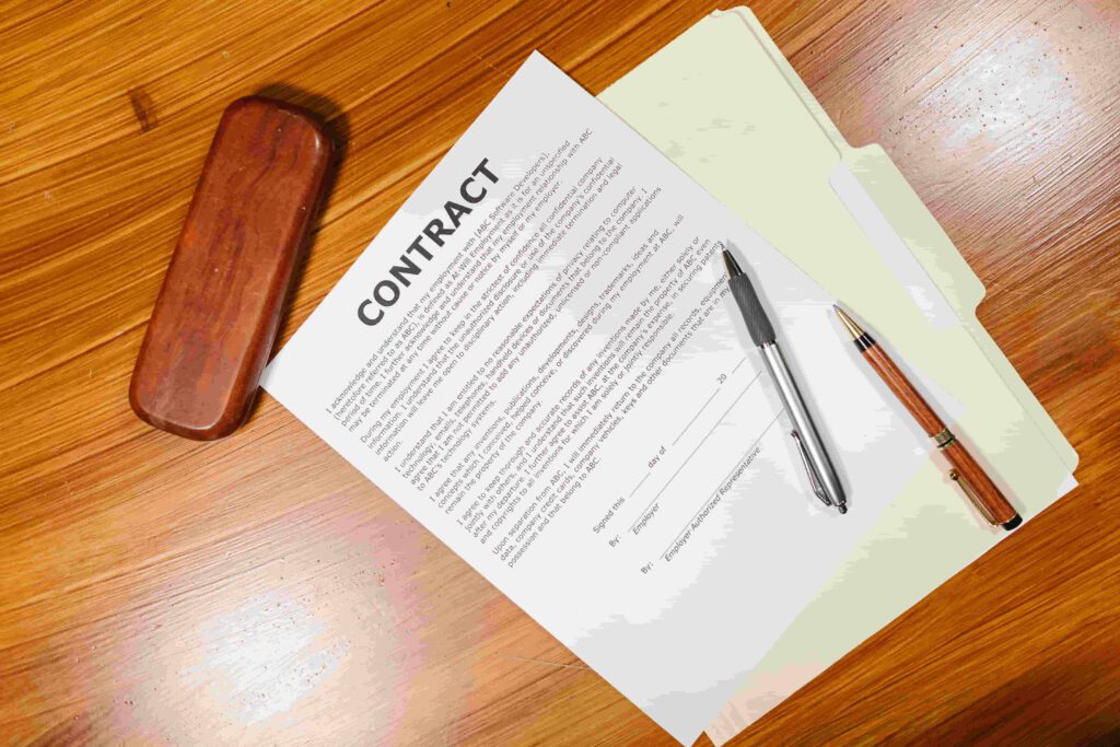 paper contract on table with pens